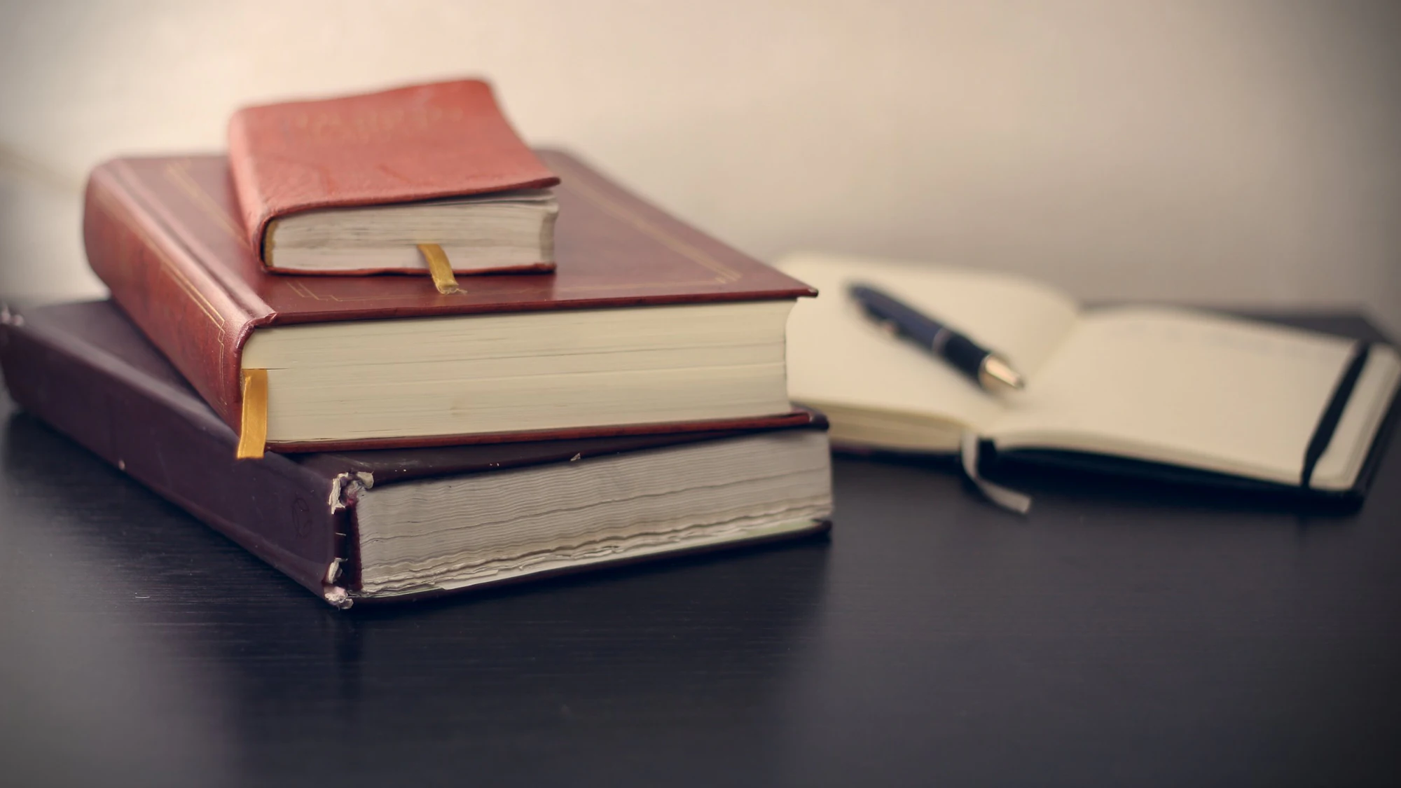 Bound law volumes beside an open notebook and pen