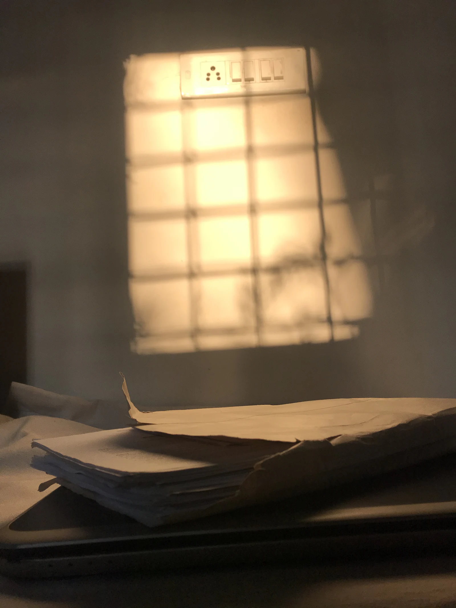Soft window light falling across paper on a desk